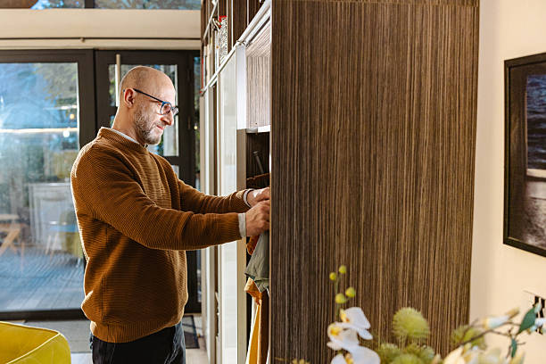 istock Man organizing items in a wardrobe at home during a cozy afternoon 2207063917