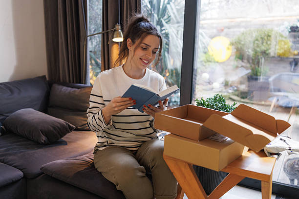 istock Young woman opening her new delivery package 2207063993