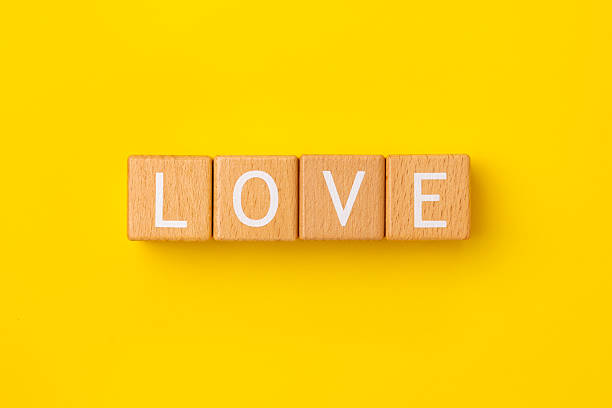 istock Block Words with Love on a Yellow Background 2207064444