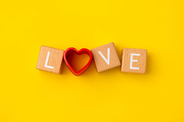 istock Block Words with Love on a Yellow Background 2207064446
