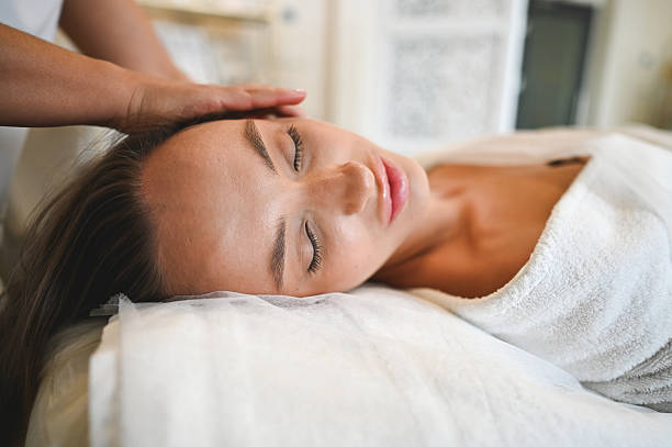 istock Young woman enjoying a relaxing head massage at the spa 2207065920