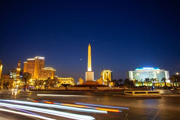 Cairo, Egypt - March 1, 2025: : Famous Ramses II obelisk and Tahrir Square with traffic ,  evening view, Cairo, Egypt