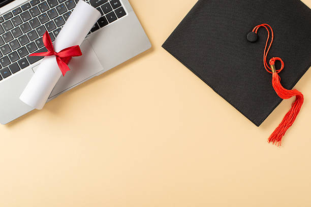 istock Graduation items, including a cap with a tassel, diploma, and a laptop, arranged 2207067769
