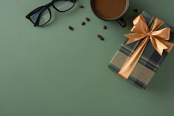 istock Elegant presentation featuring a gift box with ribbon, eyeglasses, coffee cup, and beans. Ideal for special occasions like Father's Day or gifts theme 2207067775