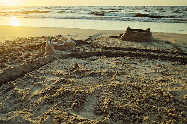 istock Sandcastle with moat on the Baltic beach at dusk. 2207068039