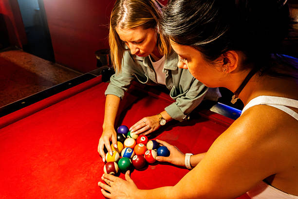 istock Female friends arranging pool balls in a pool hall 2207068461