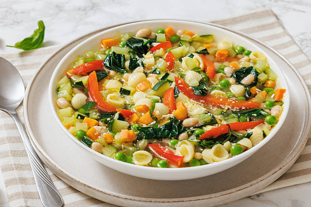 istock Vegetarian Minestrone with in white bowl, top view 2207070066