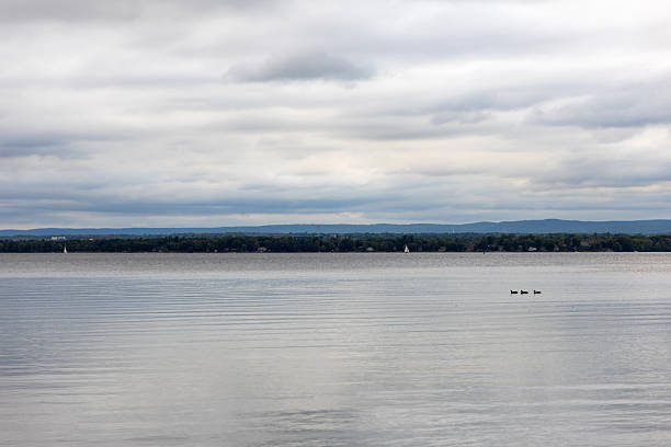 Cloudy sky and river on an overcast day. Riverside in summer. Ottawa river in Canada