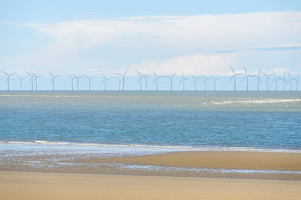 istock Offshore wind turbines on a sunny summer day 2207071498