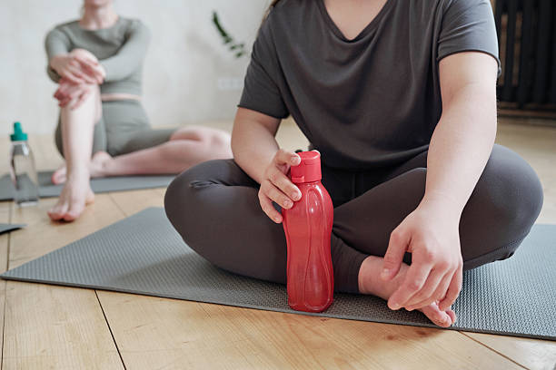 istock Active female having water at break after yoga training 2207077141