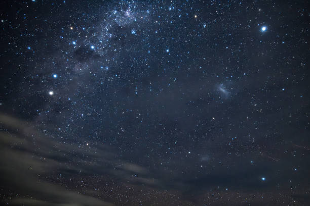 istock Stargazing at the night sky and milky way with clouds 2207077486