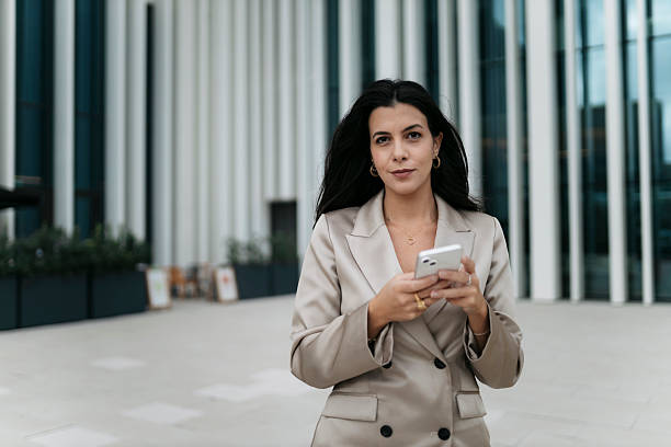 istock Confident businesswoman using smartphone in urban setting 2207078845