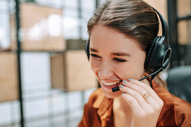 istock Close up of confident customer support operator, wearing headset, smiling in call center 2207080977