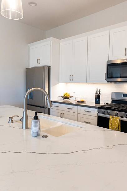istock A kitchen with white cabinets, stainless steel appliances, and a sink 2207082411