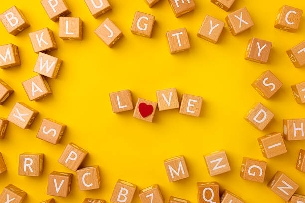 istock Block Words with Love on a Yellow Background 2207083079
