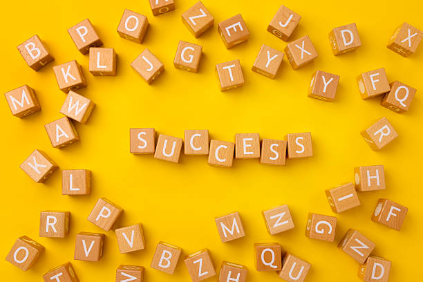 istock Block Words with Success on a Yellow Background 2207083987