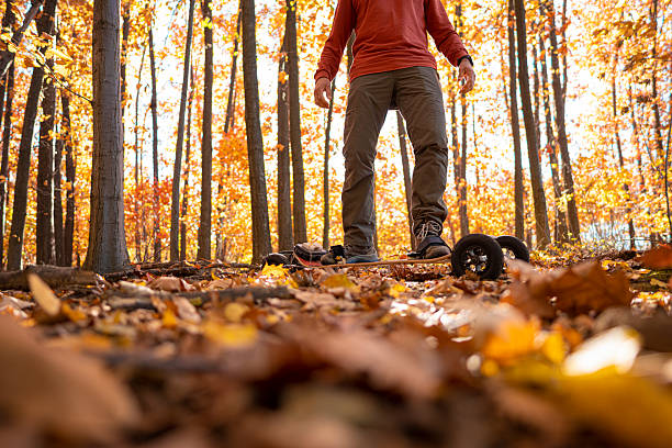 istock Electric Mountainboarding In Autumn Forest. Sustainability 2207090464