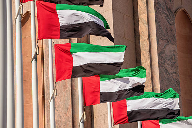 istock Multiple UAE flags waving proudly on tall poles, symbolizing national pride and unity 2207090995