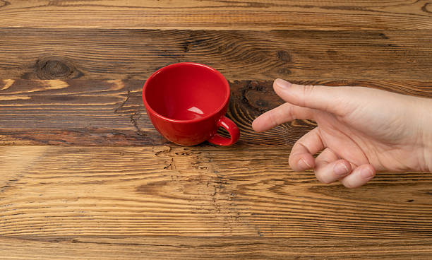 istock Hand Holds Cup, Empty Red Cup in Hands, Coffee Mug, Teacup, Hot Beverage Mockup 2207096208
