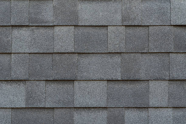 istock Overlapping sheet of soft gray asphalt shingles 2207096870