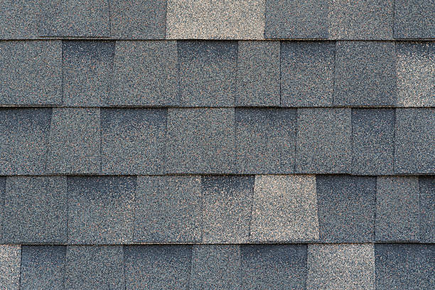 istock Close-up texture of dark gray asphalt roofing shingles 2207096889