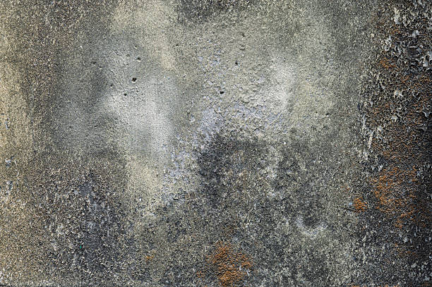 istock Textured Concrete Wall with Cracks, Stains, and Weathered Discoloration 2207097428