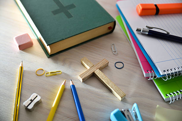 istock Religious education concept with crucifix and Bible and tools around 2207098945