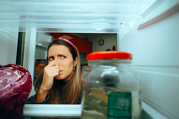 istock Unhappy Woman Feeling a Bad Smell Coming from her Refrigerator 2207102477