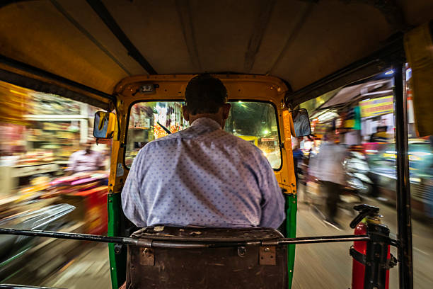 istock Indian man drives auto rickshaw (tuk-tuk), India 2207103031