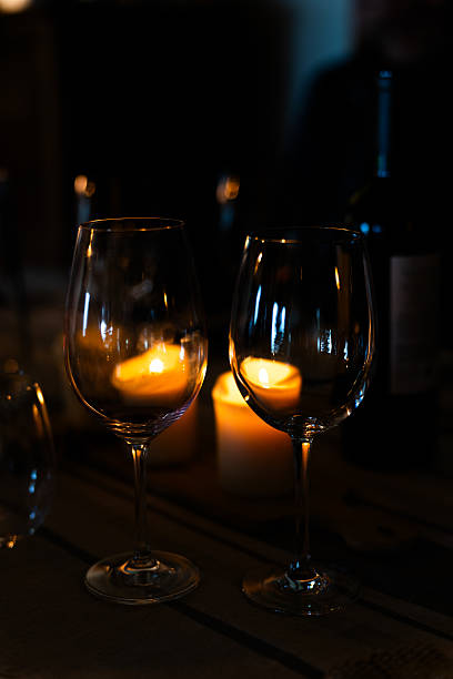 istock Romantic dinner table with candlelight and wine glasses 2207104735