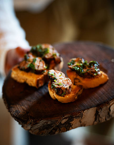 Serving sweetbread tapas Argentine style on a wooden board