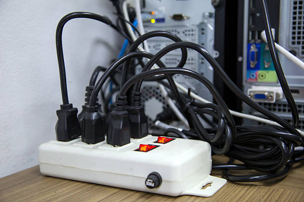istock Old and damaged electric adapter power plug has many appliances are plugged outlet socket concept of risk danger overloaded current electrical. 2207105606