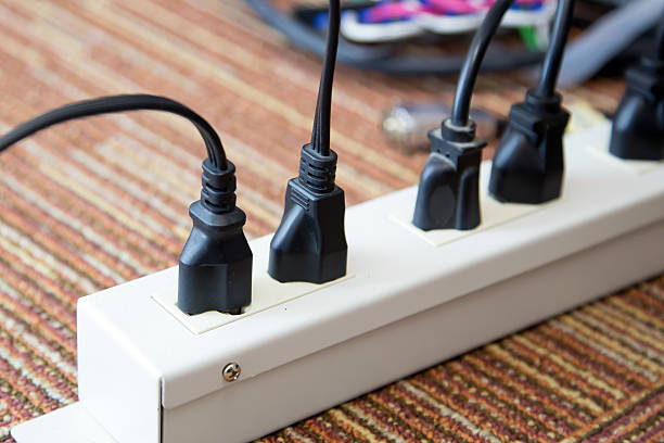 istock Old and damaged electric adapter power plug has many appliances are plugged outlet socket concept of risk danger overloaded current electrical. 2207105607