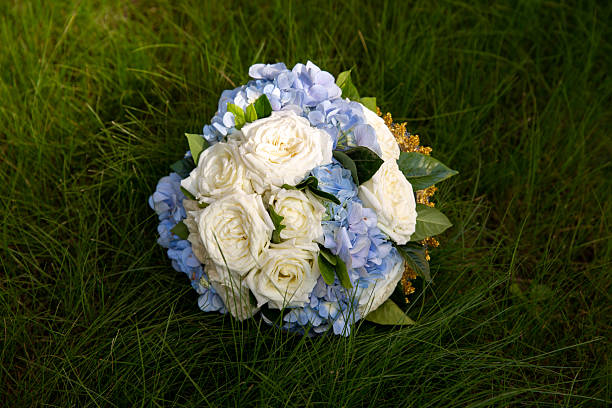 bride/ bridesmaid/ prom in light green strapless dress holding a bouquet. Natures background