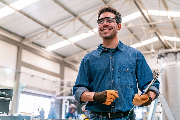 Happy supervisor working at a metallurgy factory and smiling