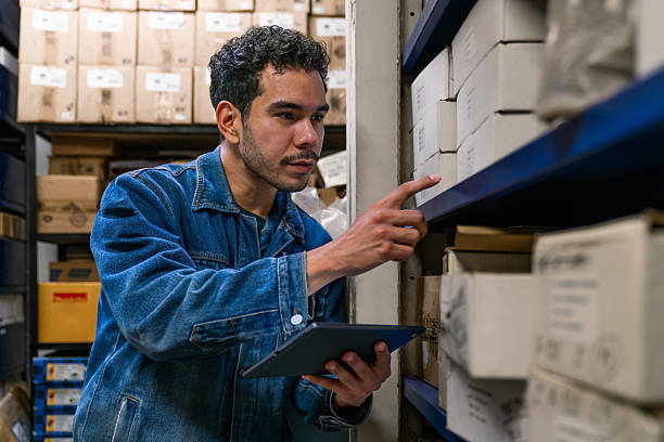 istock Employee working at a hardware store taking inventory of the merchandise 2207107071