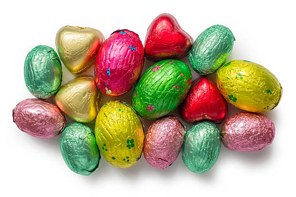 istock Set of chocolate candies in multi-colored foil on a white background. 2207117213