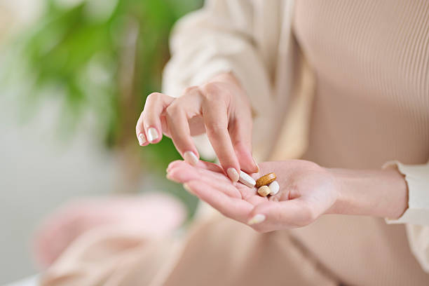 istock A 20-something woman taking a supplement in bed 2207118895