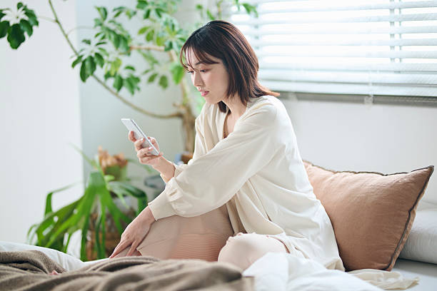 istock A woman in her 20s looking at her smartphone in bed 2207119035