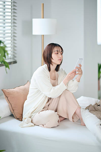 istock A woman in her 20s looking at her smartphone in bed 2207119959