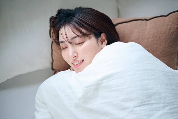 istock A 20-something woman lying in bed 2207120100