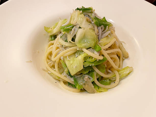 istock Pasta with boiled whitebaite and spring cabbage in garlic sauce 2207121190
