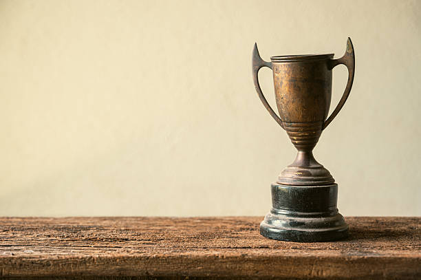 istock Vintage Trophy on Wooden Table with Neutral Background 2207122212