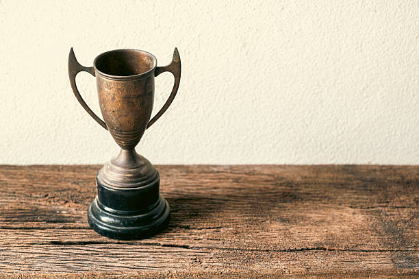 istock Vintage Trophy on Wooden Surface in Natural Light Setting 2207122215