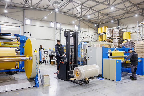 istock Man operating forklift, loading bales of electrical insulation tape in distribution warehouse 2207124200