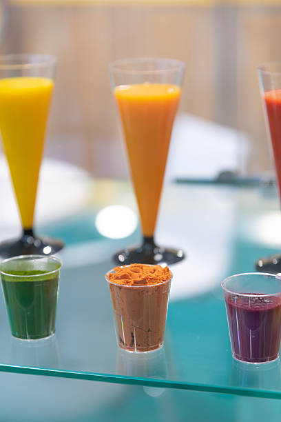 A variety of Colorful array of drinks and powders (variety of food colorings) displayed at a festive event. Bright hues attract attention in a vibrant setting during a lively festival atmosphere.