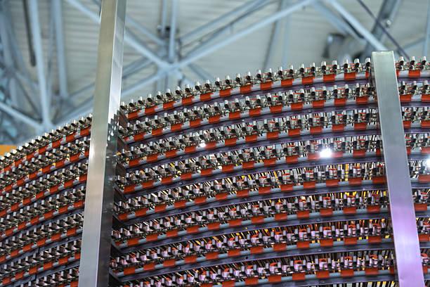 Inside a high-tech manufacturing plant, numerous metallic components are arranged in a circular pattern. The complex design highlights advanced engineering techniques used for precision assembly.