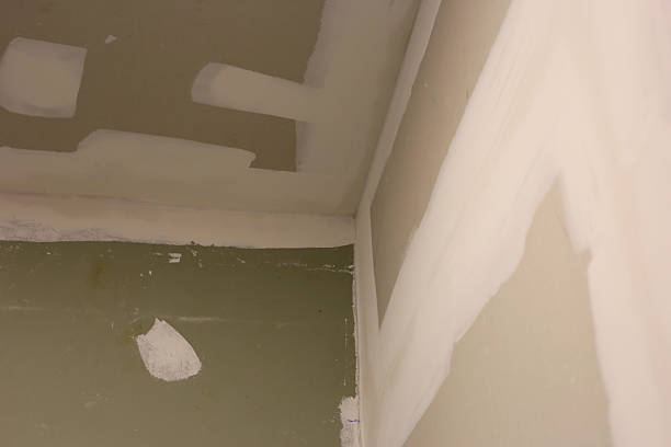 istock Gypsum board wall and ceiling installation at a house construction site 2207127717