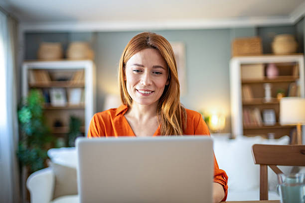 Front view of smiling woman working on laptop