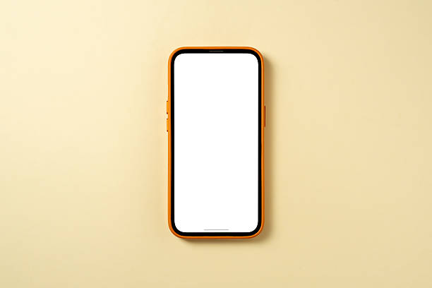 Top view of smartphone with blank screen on yellow background